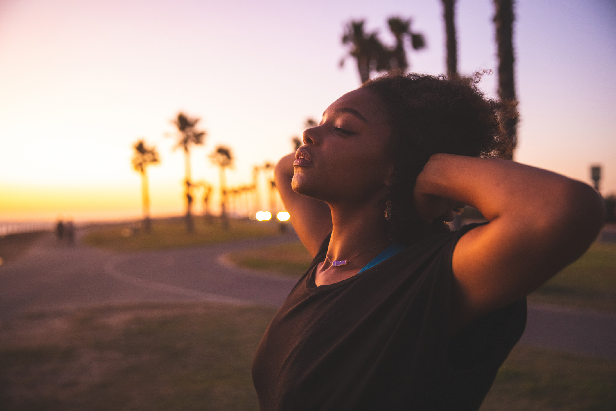 calm woman relaxing with hands behind her head