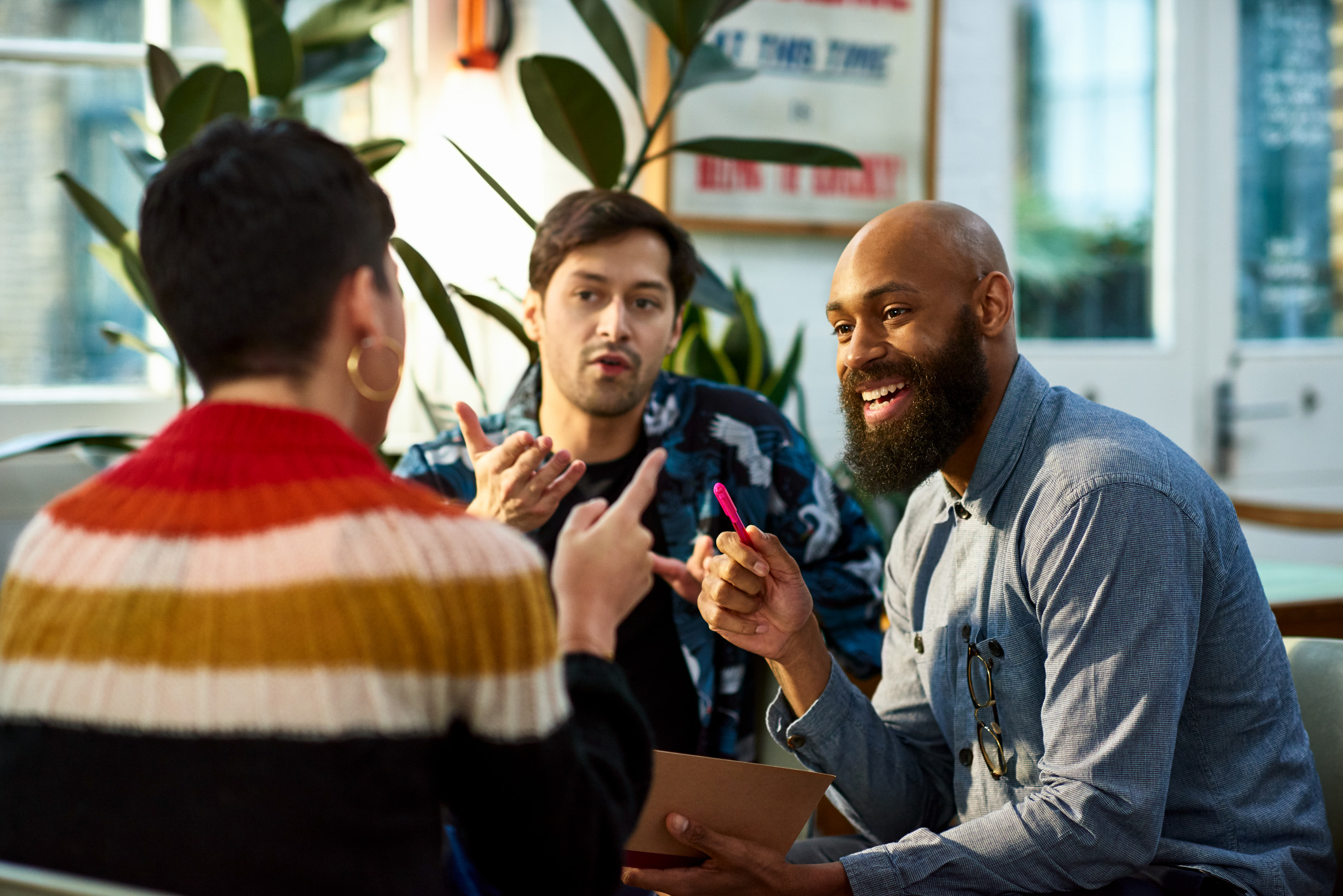 Group smiling and talking at work