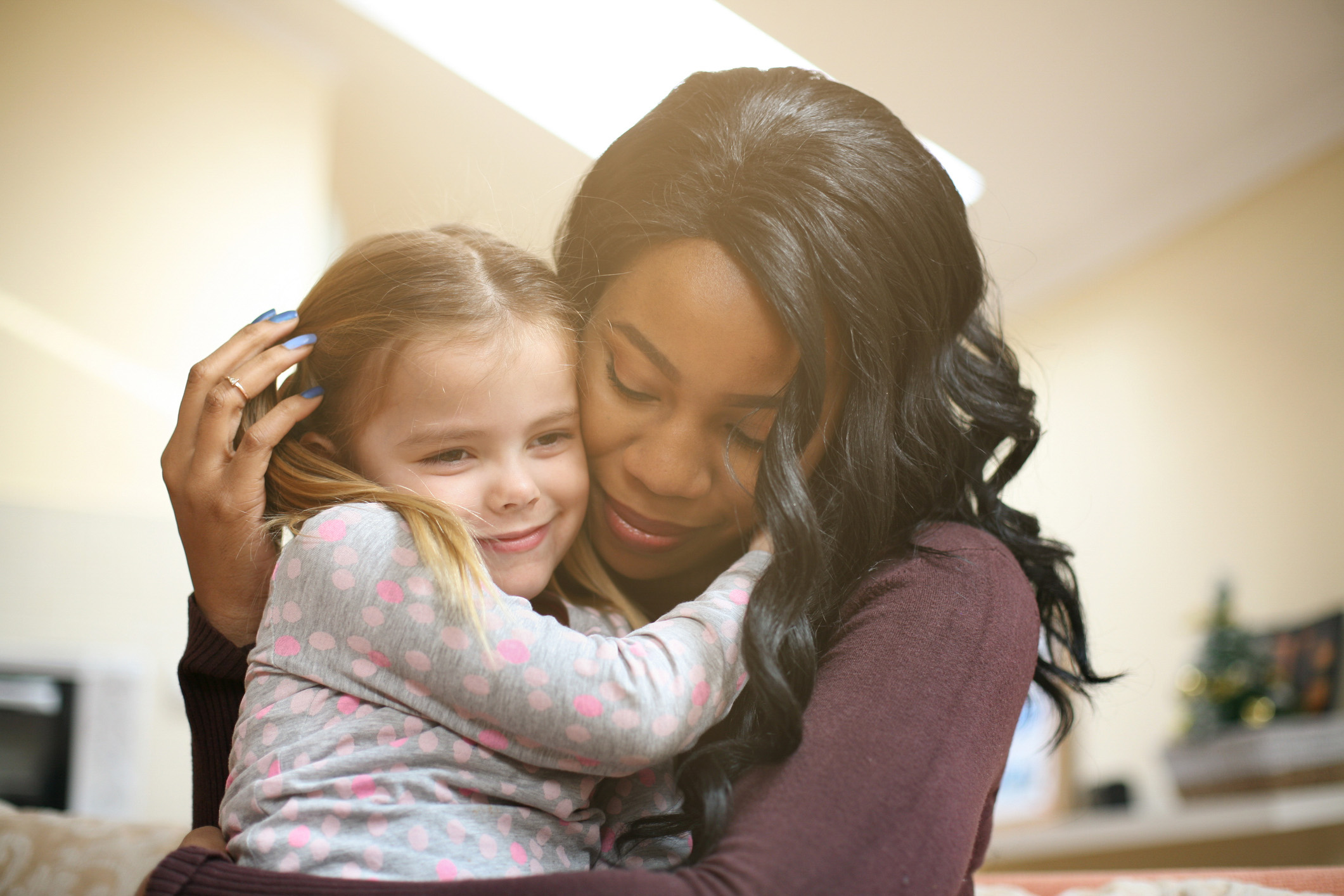 Woman holding her adopted daughter