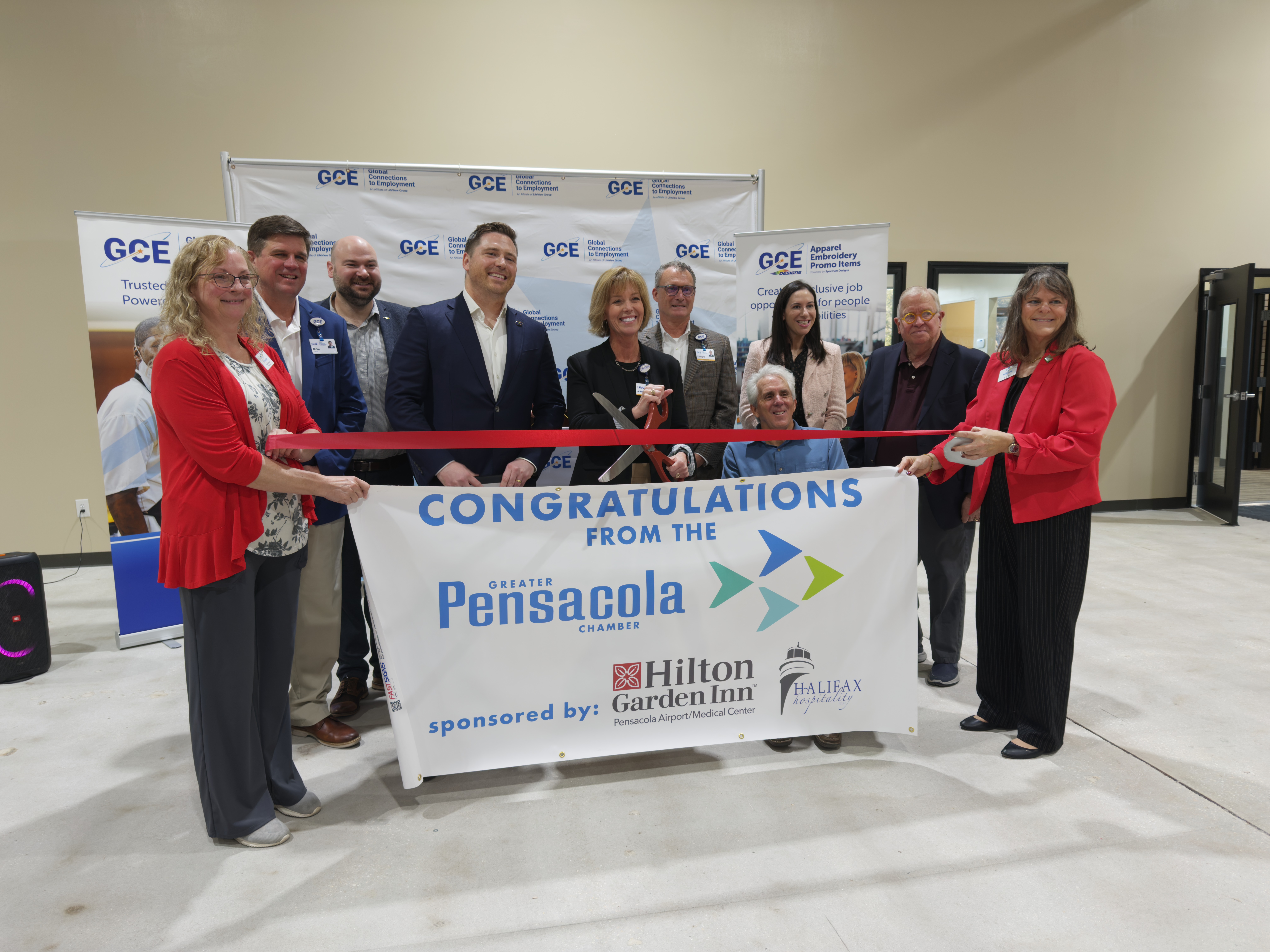 GCE, LifeView, and Spectrum Designs leaders pose alongside the Greater Pensacola Chamber for a ribbon cutting